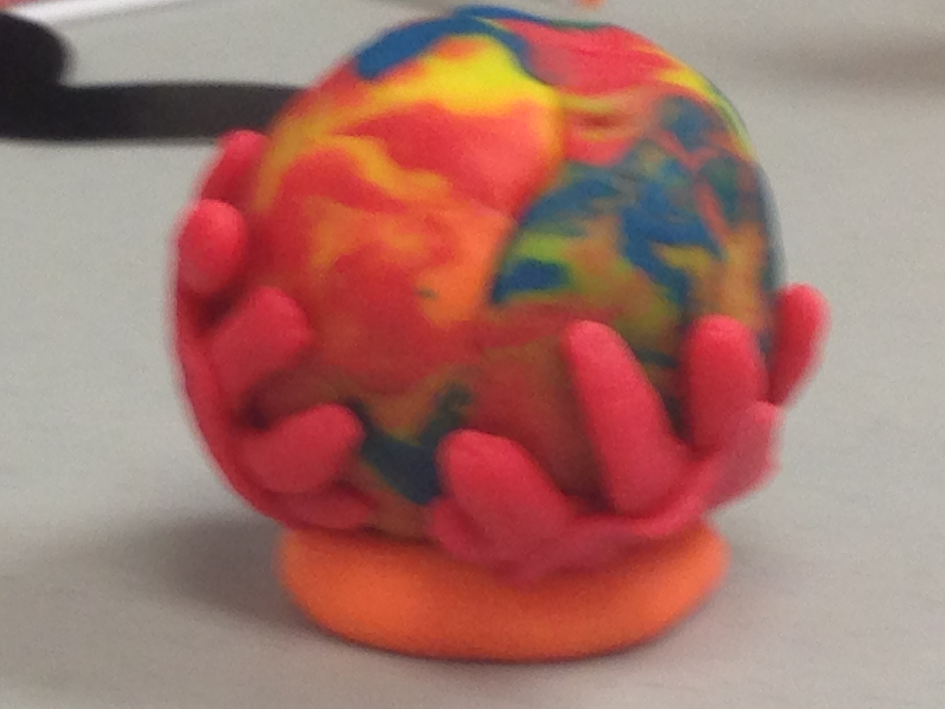Clay sculpture of world in hands