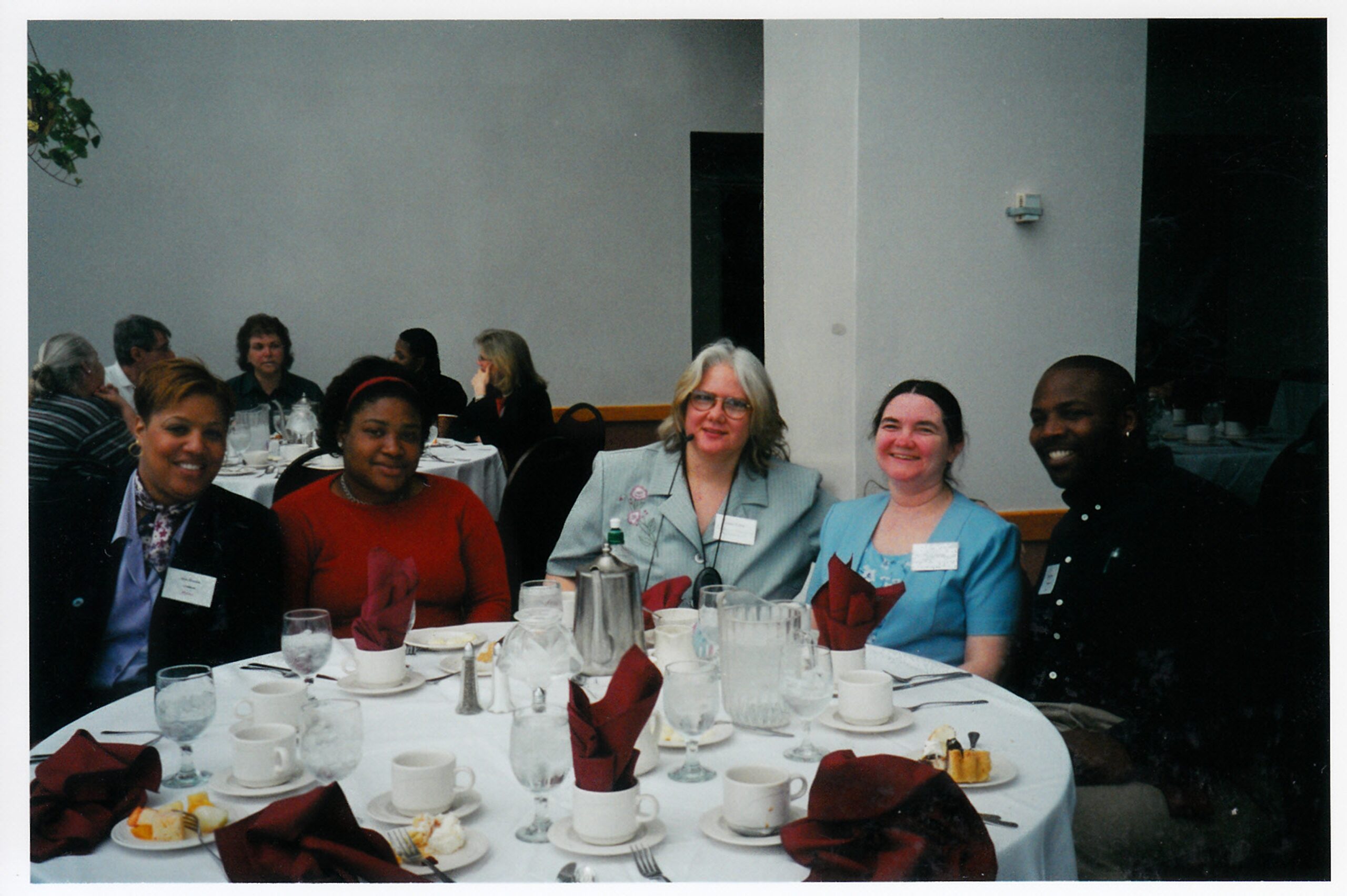 A throwback of Diane and Doris pictured with others around a table at a banquet event.
