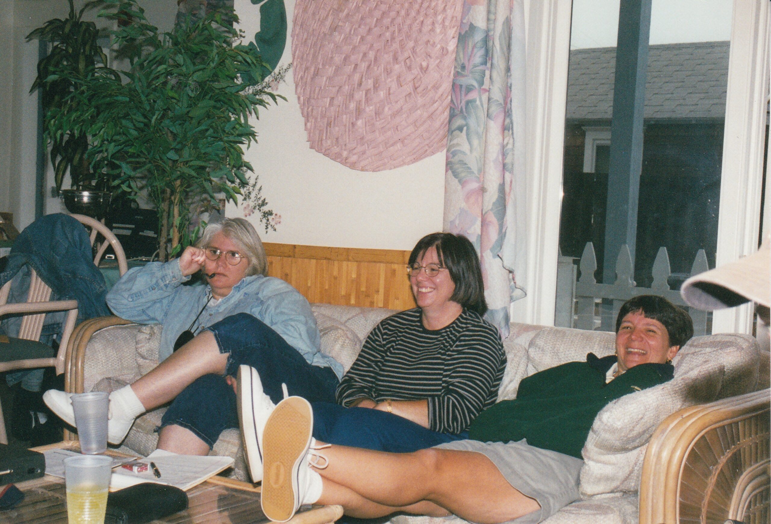 Diane, Leslie Seese and another person relaxing on the couch at a retreat.