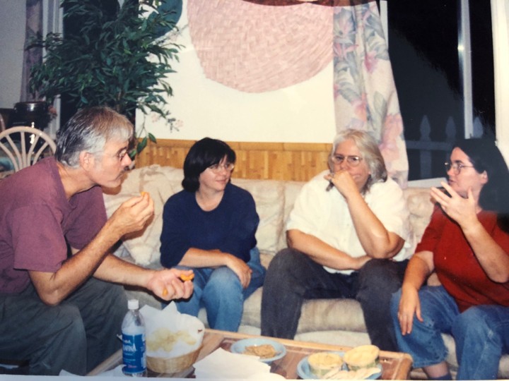 Mike, Diane, Doris and 1 other person in a deep conversation on a couch.