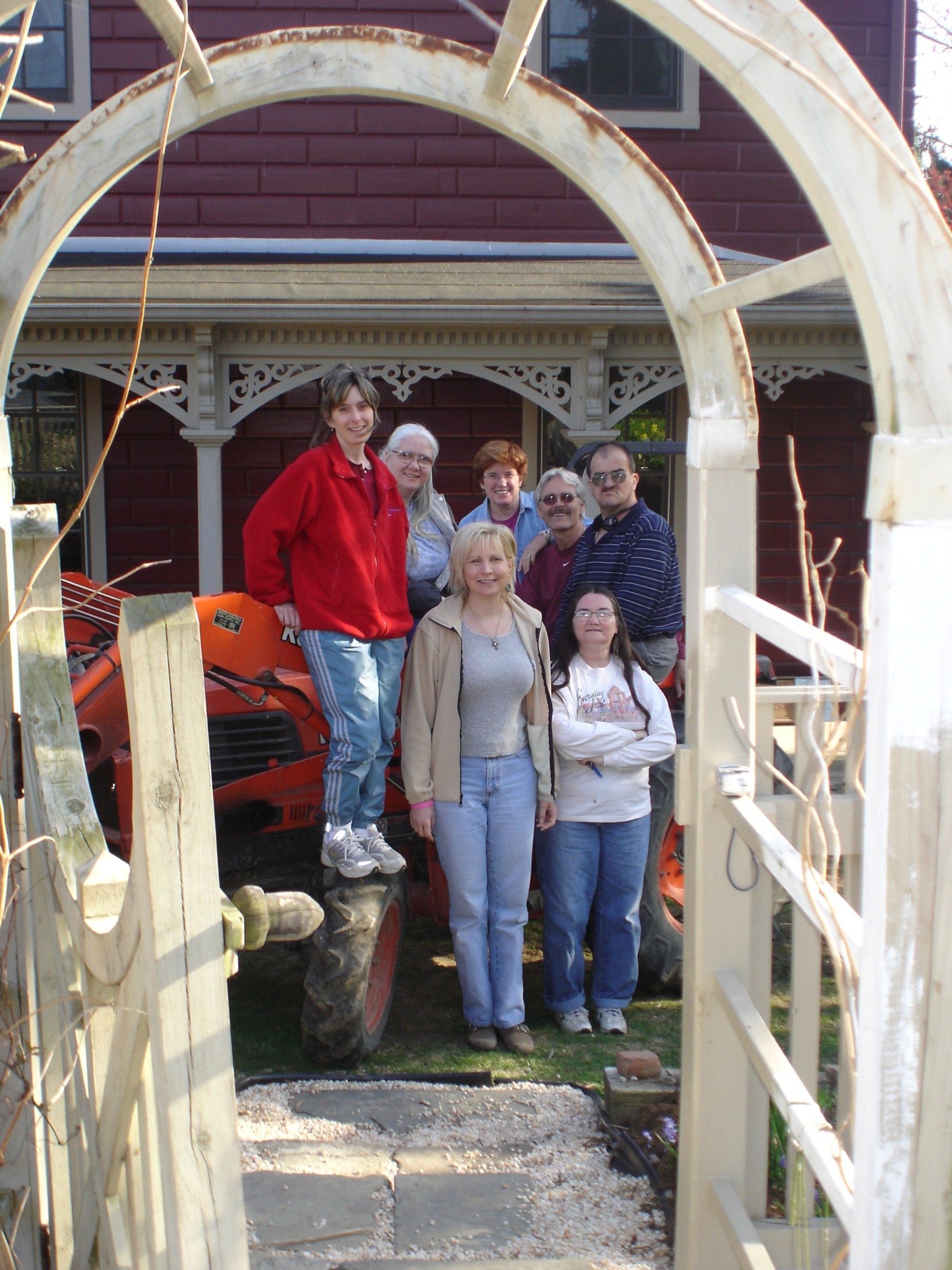 Michelle, Donna, Doris, Diane, George, Rosa, and Mike posing by a tractor at Mary Lapos’.