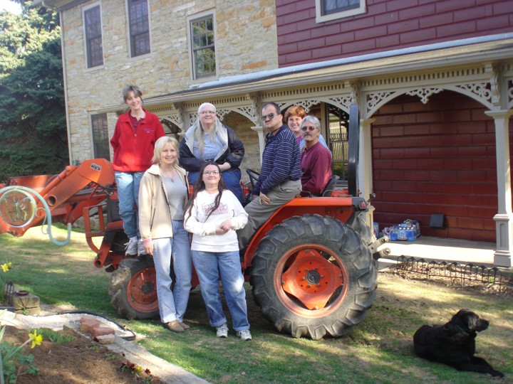 Michelle, Donna, Doris, Diane, George, Rosa, and Mike posing on a tractor at Mary Lapos’.