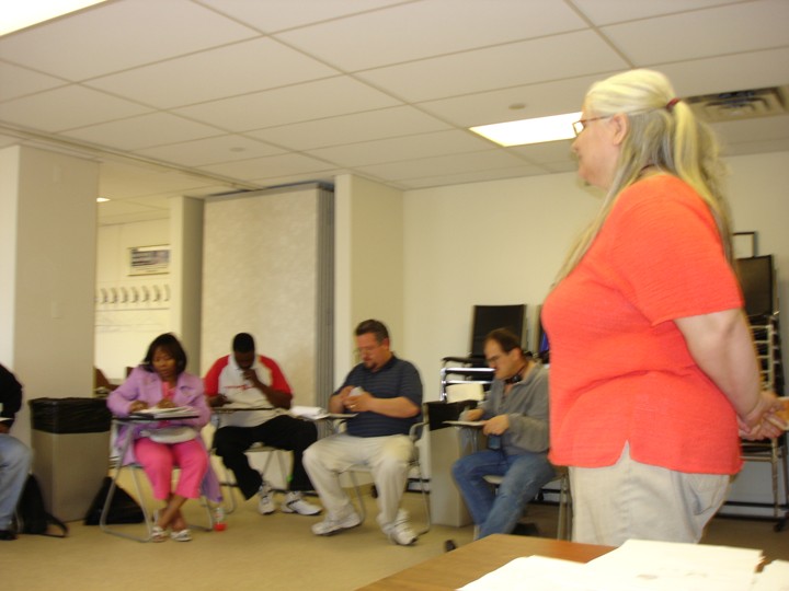 Diane facilitating a training at 123 S. Broad conference room to a room full.