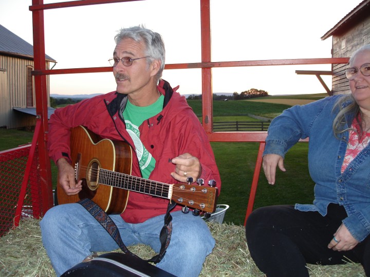 Mike and Diane taking a hayride at Mary Lapos. Mike is playing the guitar.