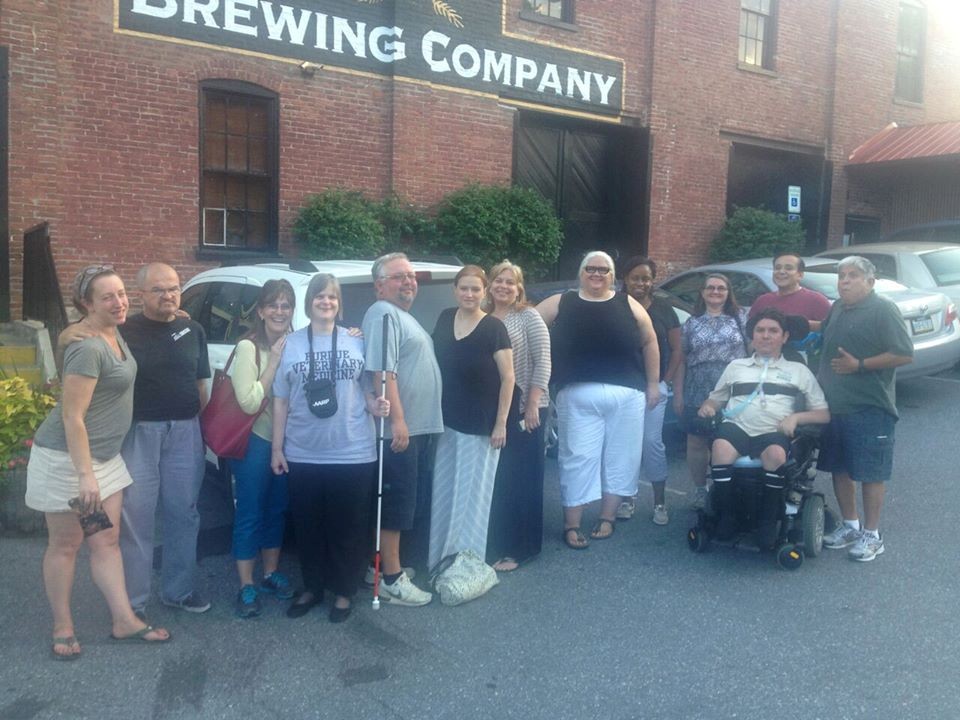 Jess, George, Suzanne, Michelle, Joe, Stacey, Julie, Diane, Doris, Andrew, Gonzalo and Andrew’s nurse at a retreat in rural PA. Posed outside of a brewing company sign.