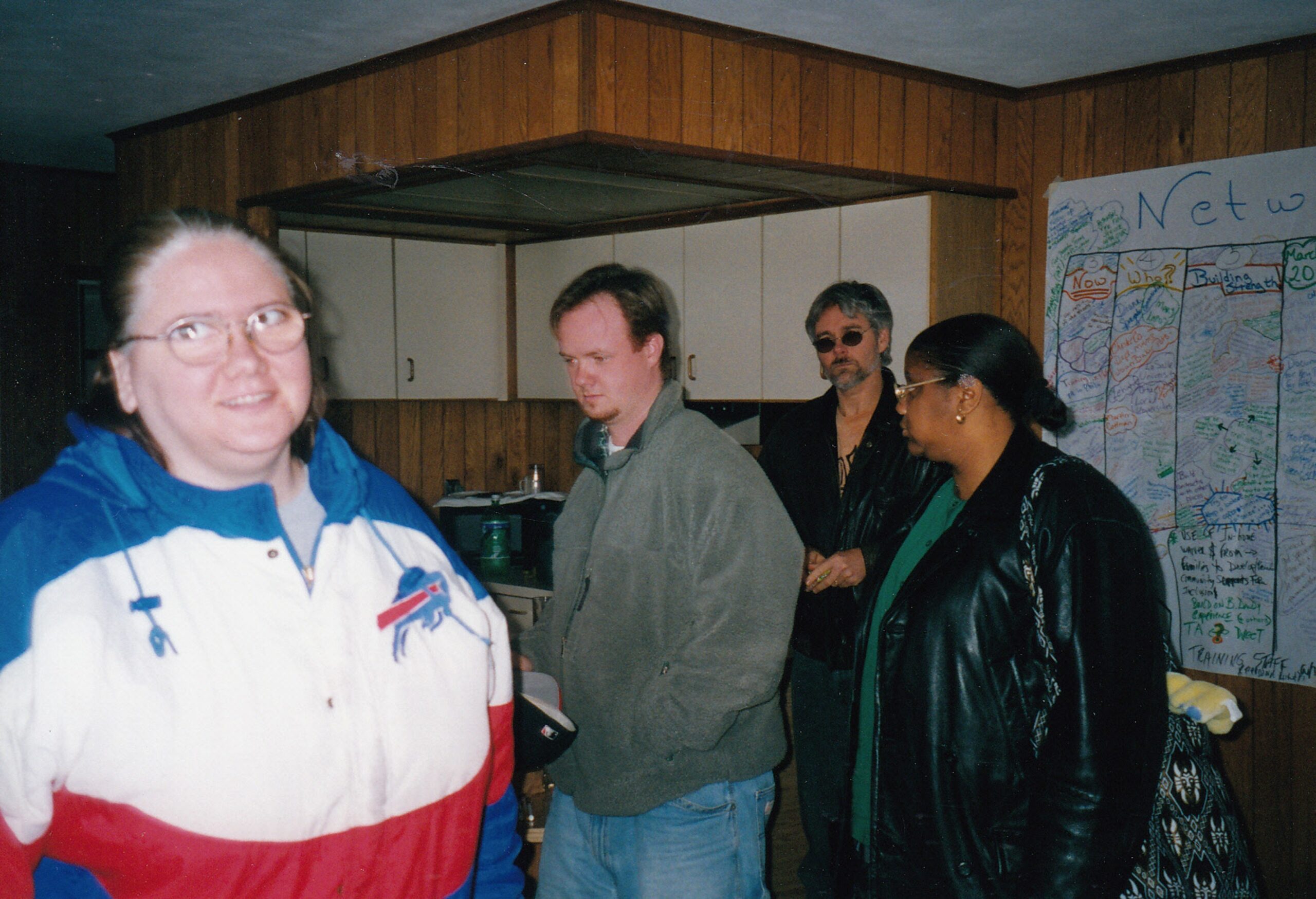 Diane, Mike and 2 others at a strategic planning retreat. There is a PATH hanging in the background.